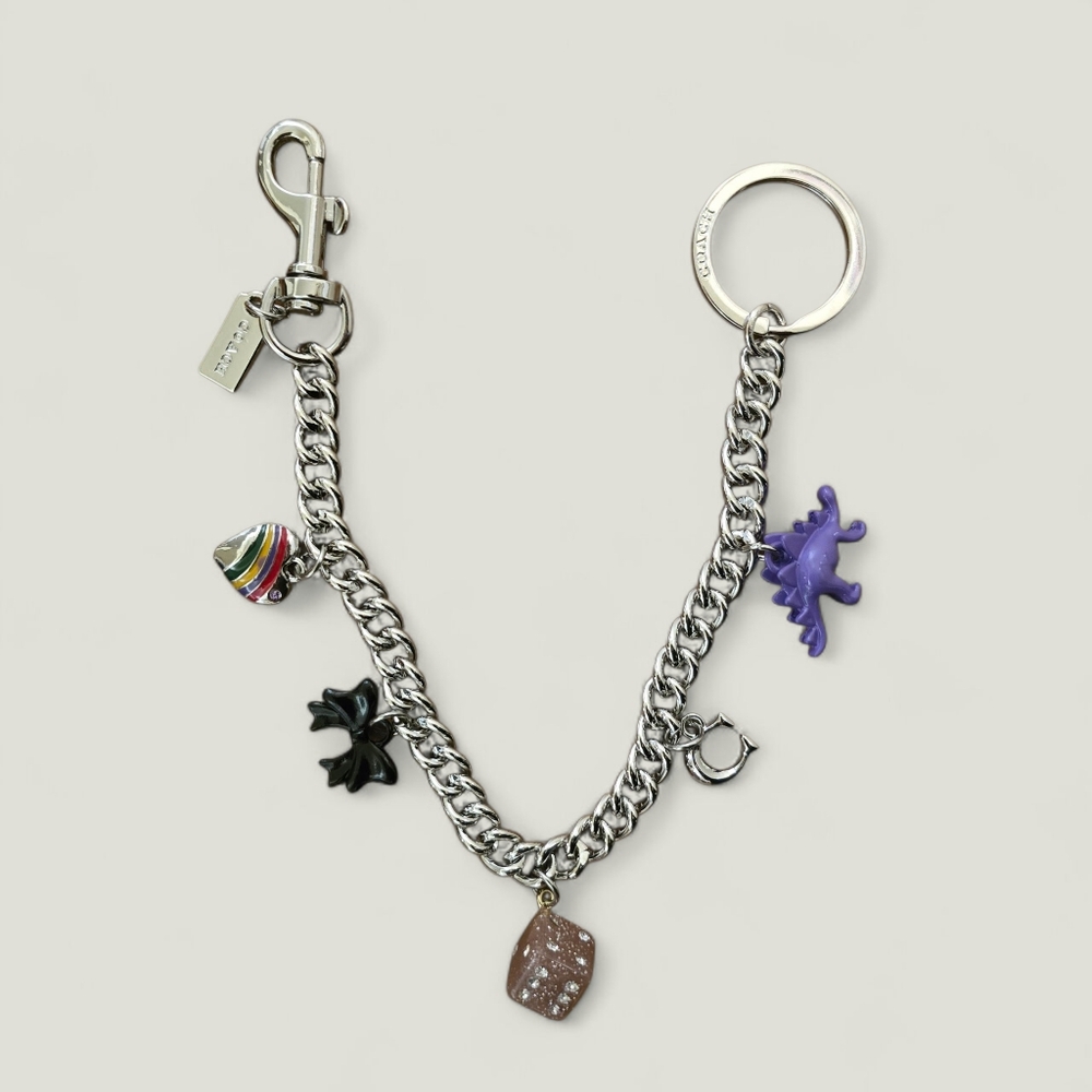 Coach Silver Keychain with Purple Dinosaur and Black Bow